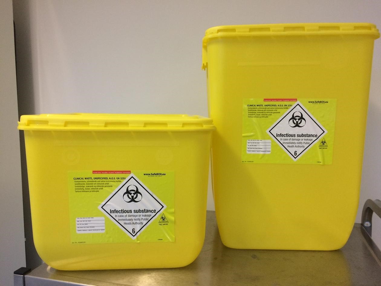 Photo of 2 large yellow containers for collection of hazardous waste