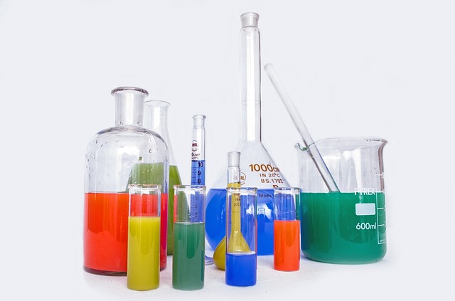 photo of various glass jars, pipettes, chemical containers etc containing various coloured solutions 