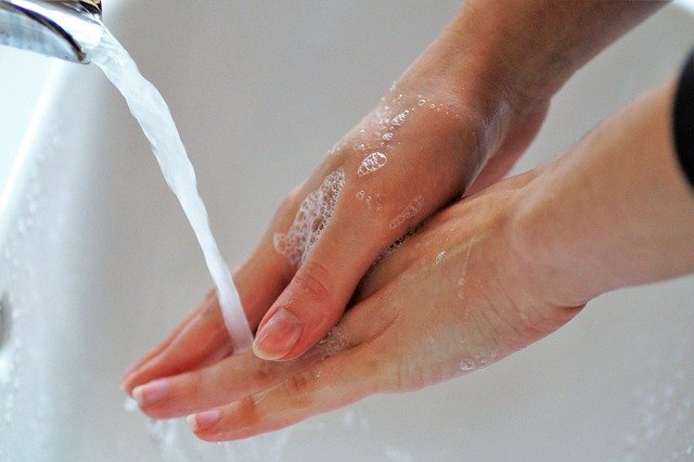 photo of someone washing hands with soap and water